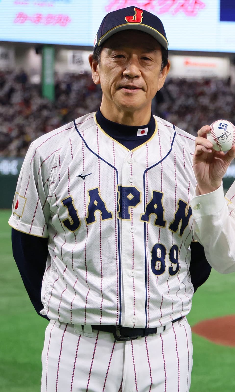 Hideki Kuriyama as Samurai Japan manager at the World Baseball Classic ceremonial first pitch in Tokyo on March 10, 2023 — months before Japan’s title run, years after he protected Ohtani’s two-way path in Hokkaido.