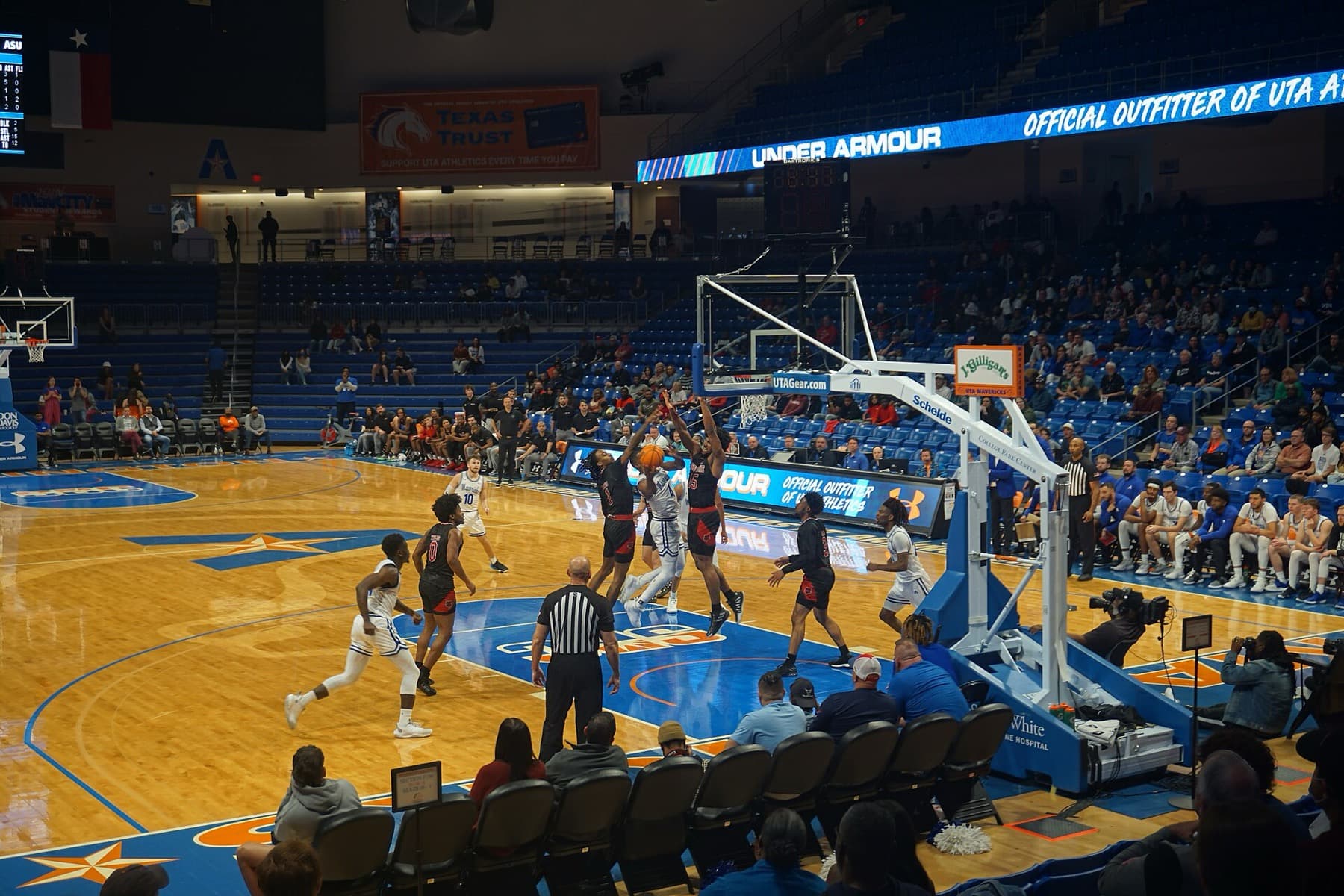 College basketball action between Arkansas State and UT Arlington — the screen-and-roll still runs through every level of the game.