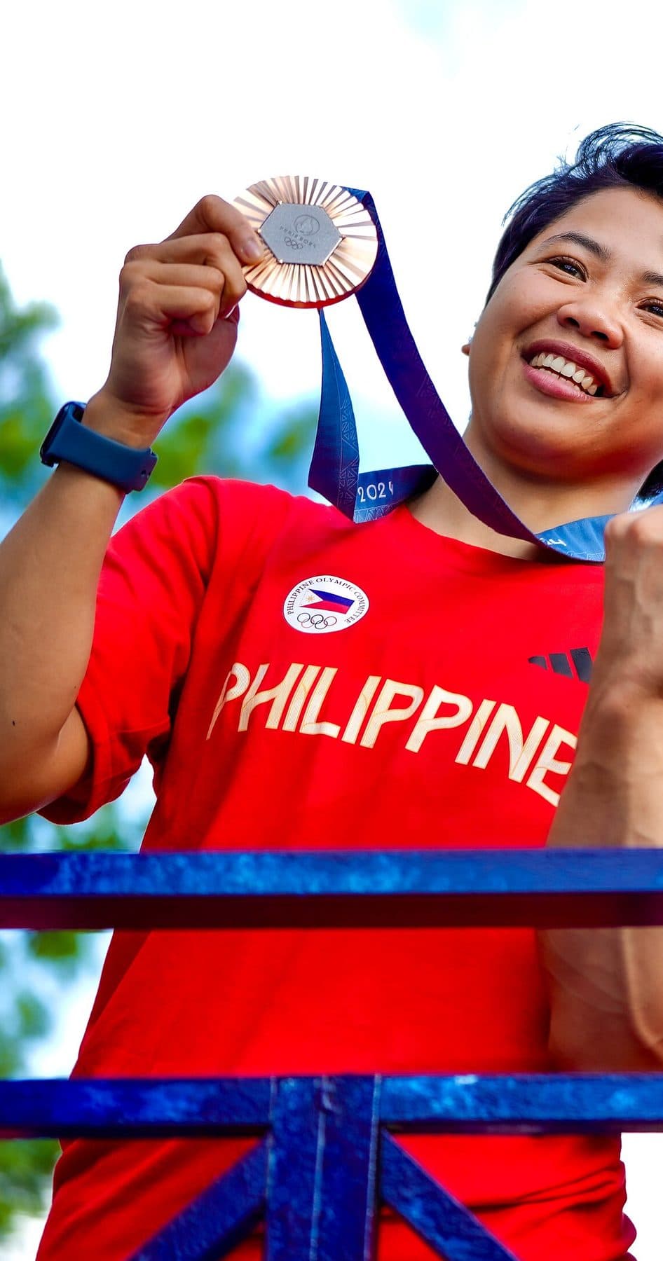 Nesthy Petecio holding her Paris 2024 bronze medal during the Philippine Olympic homecoming parade in Manila, August 2024.
