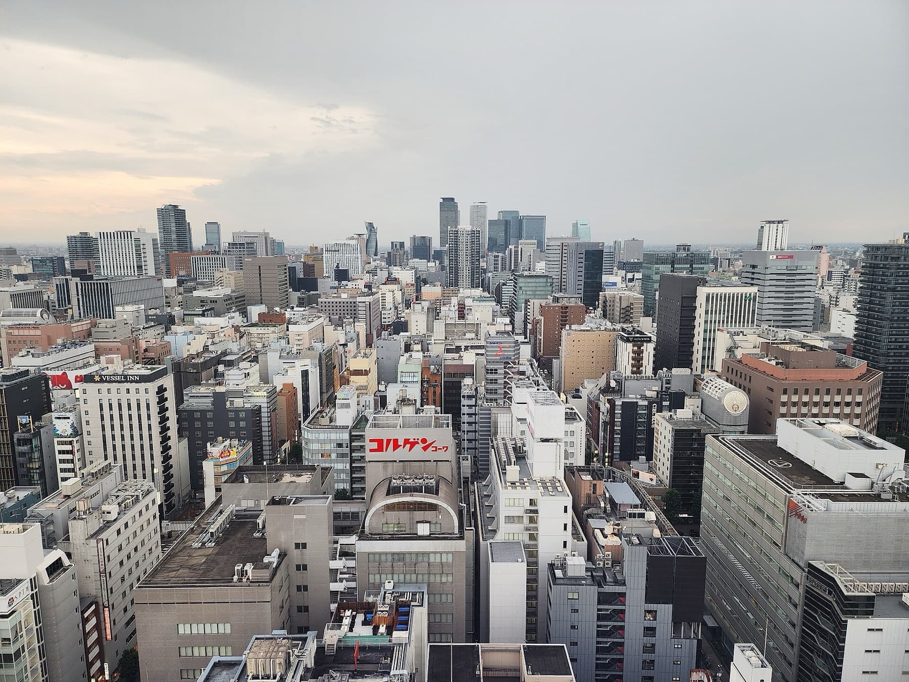 Nagoya’s Sakae skyline from Mirai Tower, looking west toward the station towers — the host-city backdrop for the 20th Asian Games in September 2026.