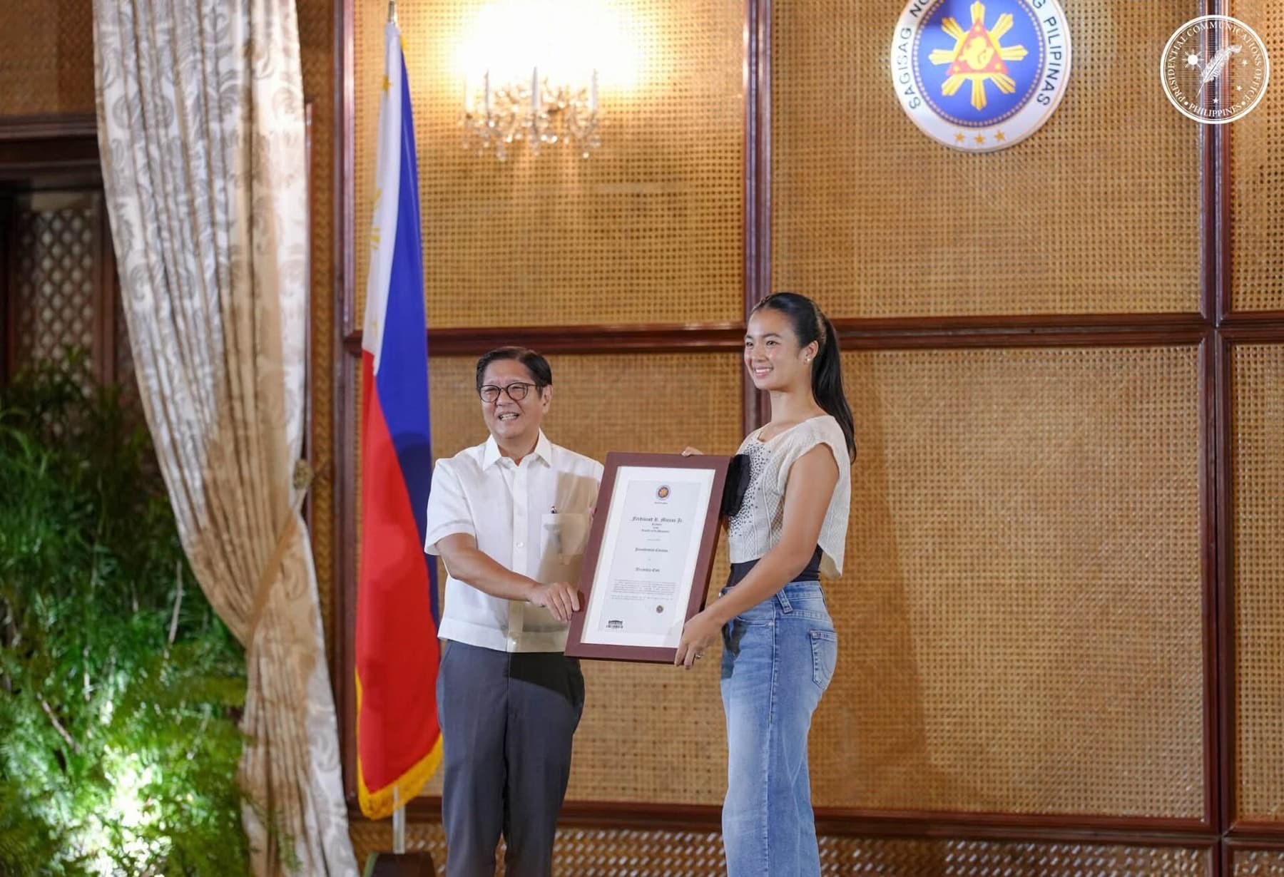 Alexandra Eala with Philippine president Ferdinand Marcos Jr. and the national flag at Malacañang Palace on July 13, 2026, after her historic Wimbledon run.