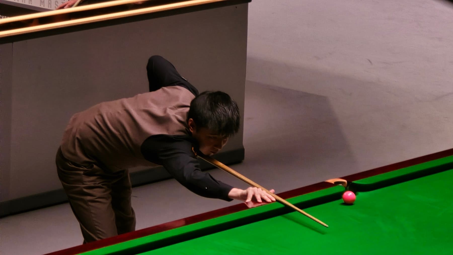Zhao Xintong lines up a shot under arena lights at the German Masters in Berlin in 2026 — China’s first Crucible champion, now world No. 3, as the China Open returns with a deep home field.