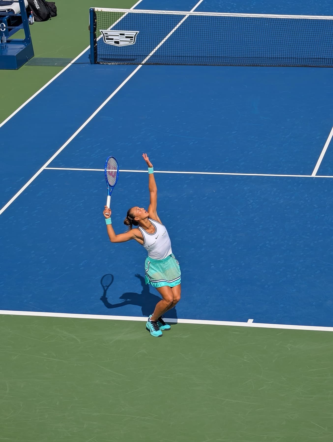 Zheng Qinwen serving in first-round qualifying at the 2026 US Open — the path she had to take after right-elbow surgery dropped her ranking outside the main-draw cut.